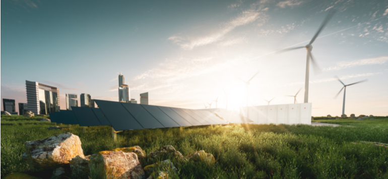 solar panels amongst wind turbines with a backdrop of a city behind