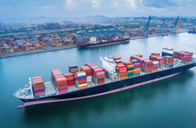 birds eye view of a container ship leaving a port