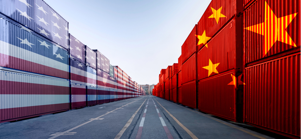 crates in a docking area with one side painted with US flag whilst the other is painted with Chinese flag