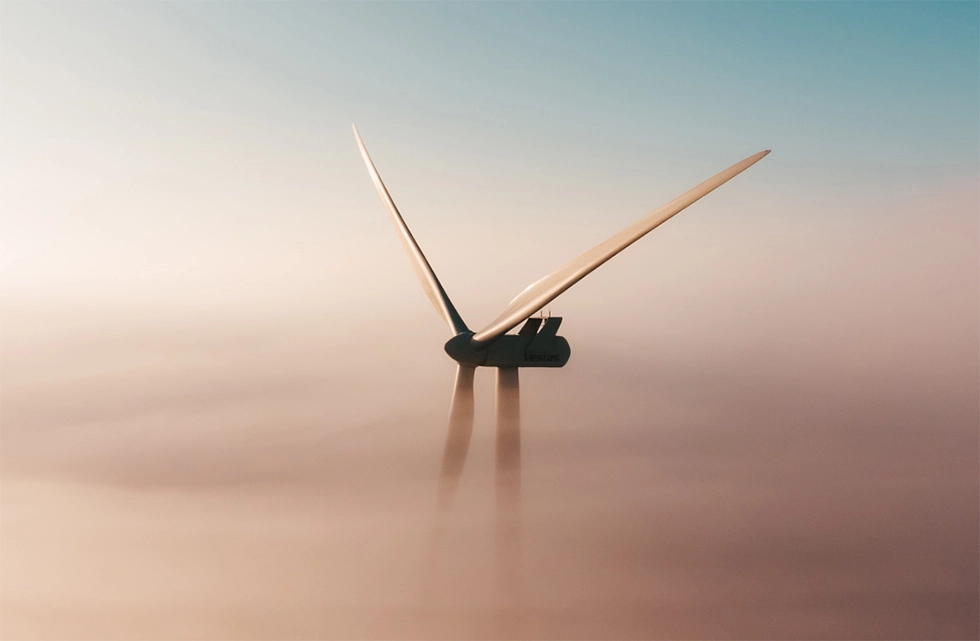 wind turbine amongst the clouds near dusk time