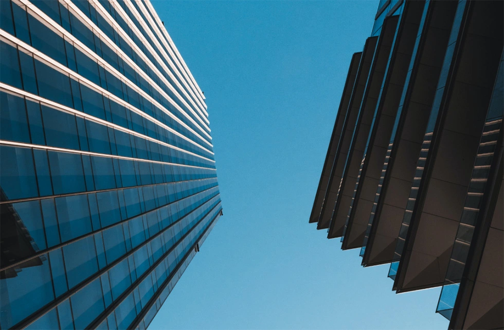 two buildings close to each other, with one building have large balconies